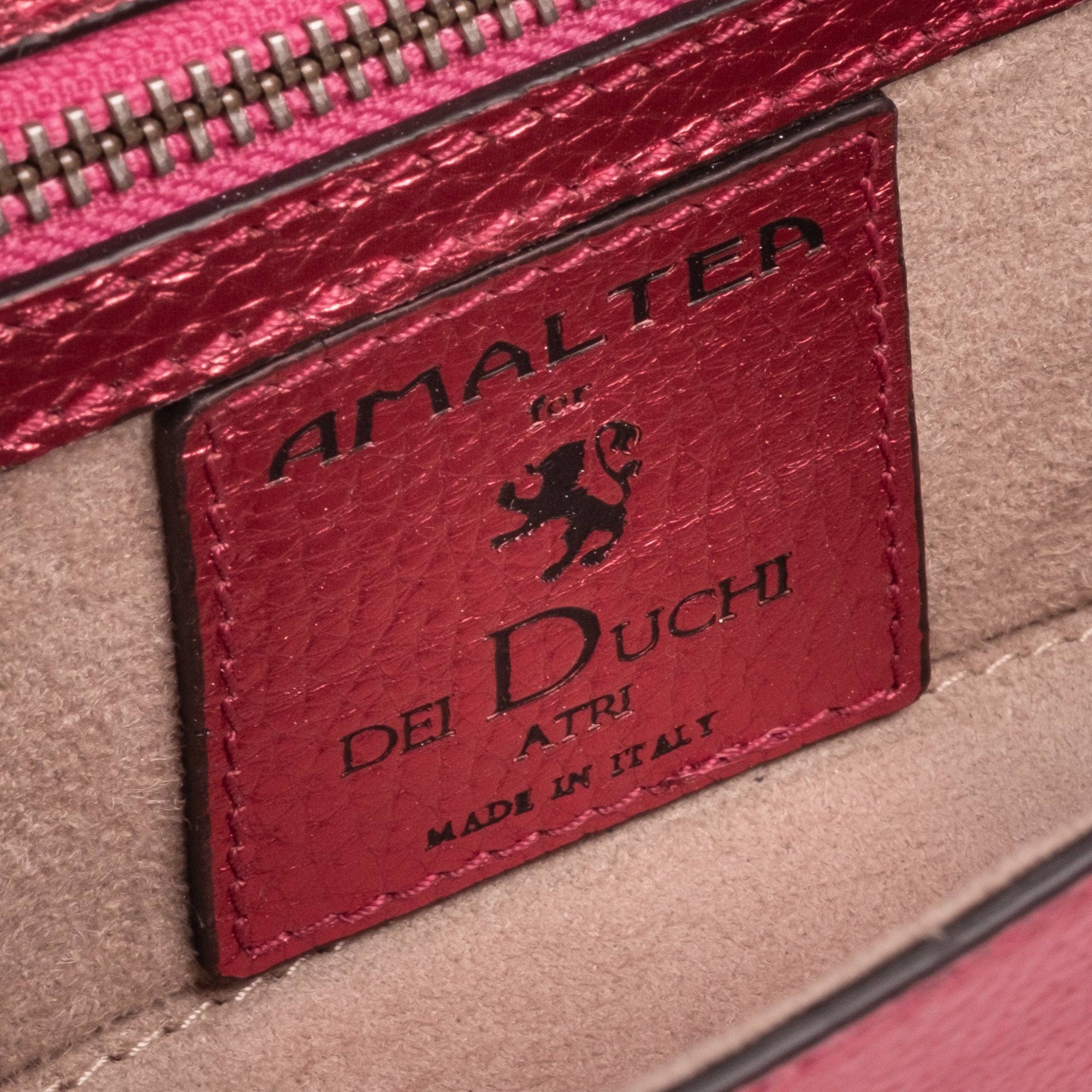 Strawberry Red leather clutch bag/wallet with a burnished metallic emblem buckle on a white background. - DEI DUCHI (AMALTEA)