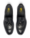 Pair of black loafers with a visible brand logo on a white background. Crust Calf. White full/grain calfskin. Tuscan tanned. Hand-dyed and antiqued leather. 9mm sole. 27mm heel height. Tuscan leather. Blake construction with bottom stitching. - Sartoria Dei Duchi - Atri