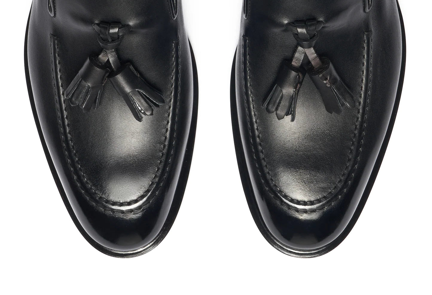 Pair of black loafers with a visible brand logo on a white background. Crust Calf. White full/grain calfskin. Tuscan tanned. Hand-dyed and antiqued leather. 9mm sole. 27mm heel height. Tuscan leather. Blake construction with bottom stitching. - Sartoria Dei Duchi - Atri