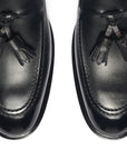 Pair of black loafers with a visible brand logo on a white background. Crust Calf. White full/grain calfskin. Tuscan tanned. Hand-dyed and antiqued leather. 9mm sole. 27mm heel height. Tuscan leather. Blake construction with bottom stitching. - Sartoria Dei Duchi - Atri
