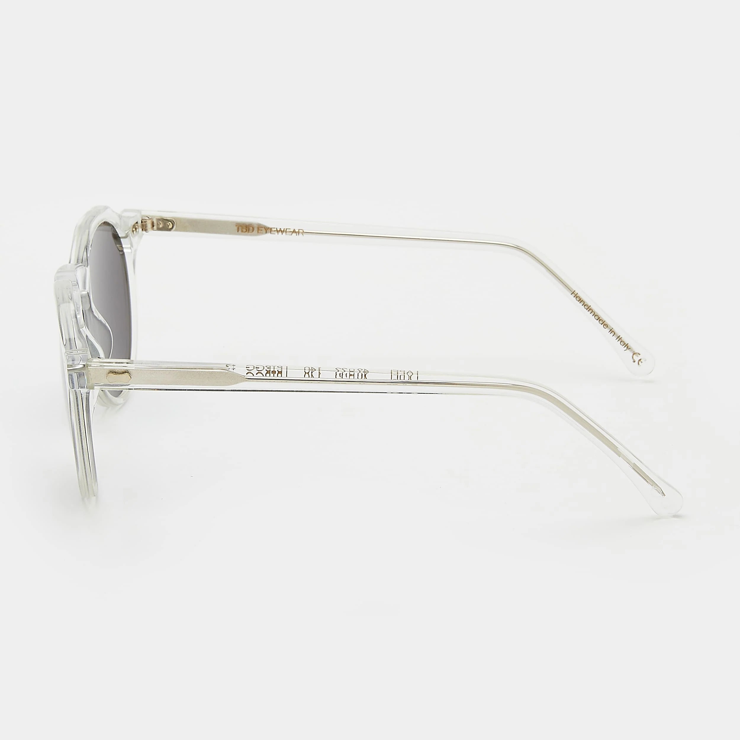 Round sunglasses with clear frame and dark lenses on a white background. - DEI DUCHI