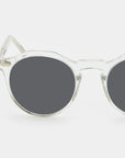 Round sunglasses with clear frame and dark lenses on a white background. - DEI DUCHI