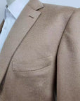 Handmade Cashmere & Vicuna jacket. Single breasted, two-button, 100% Camel Hair versions. Classic pocket trousers, handmade bird's eye pattern. No pleats on front, classic buttoning and belt loop finish. Front American pockets, classic welt pockets w/ button on back. Trousers in cotton finishes and knee pads with lining inside, center slit at the back of the belt. Button holes, pockets, under knack. Suit is fitted, yet extremely comfortable | Sartoria Dei – Duch