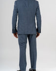 This elegant suit is made with 100% pure merino wool “Super 170s WISH” by Loro Piana. It is characterized by a checked design in shades of gray and light blue. This is a two-piece with two-button jacket with 3 pockets with flaps. One of these pockets is a watch pocket. The pants has regular rise and no darts, with american cut pockets and two back pockets. Belt with loops and zip on the front. -  Sartoria dei Duchi.