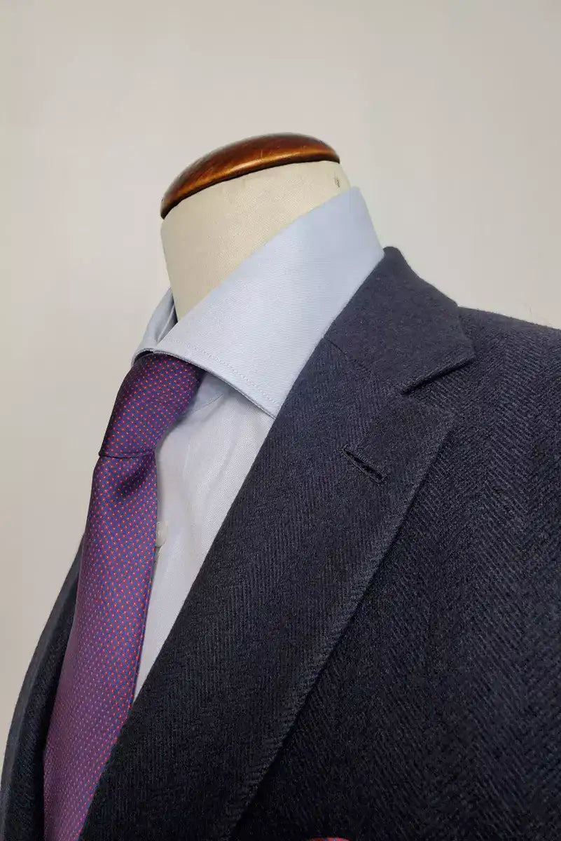 Pure finest Wool and Cashmere suit, with herringbone pattern,  suitable for A/W, fabric by Loro Piana textile.Single-breasted  two-button jacket, with classic lapel.Two slits on the back.The  slim fit trousers have no pleats and no flap on the bottom. Buttonholes, pockets, garments and all finishes are handmade  by Italian tailors.This Italian tailored suit is snug, yet extremely comfortable.  Perfect to look impeccable and professional in your business  occasions.|Sartoria Dei Duchi - Atri