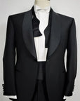 100% Mohair Wool Worsted. Single-breasted jacket w/ one button. Black silk satin shawl collar. Classic pockets. Buttons lined in silk satin. Button holes, pockets, undercollar & finishing touches are handmade. Fitted yet extremely comfortable. TROUSERS: Classic Tuxedo, w/ side band black silk satin. One pleats, slim, w/ internal buttons for suspenders w/ a black silk satin cummerbund & the sweet touch of a black bow-tie.  Also available in blue.|Sartoria Dei Duchi-Atri