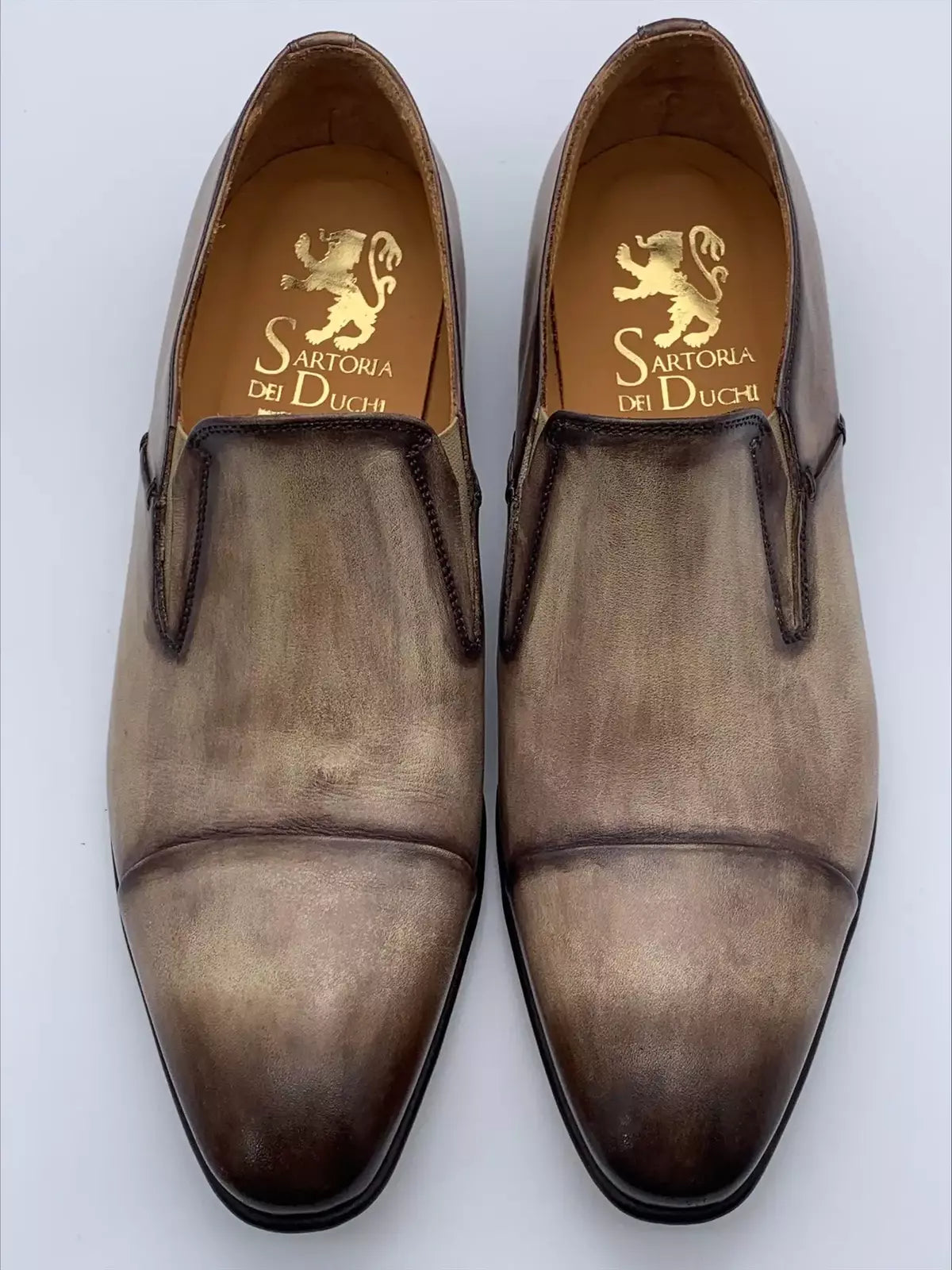 Moccasin in leather velour crust colored and antiqued by hand, sand and tobacco color, with light calfskin interior. In Blake processing the shoe is mounted on the shape and with a machine called &quot;Blake&quot;, the sole is sewn to the insole and upper. This process guarantees the tightness of the bottom.| Sartoria Dei Duchi - Atri