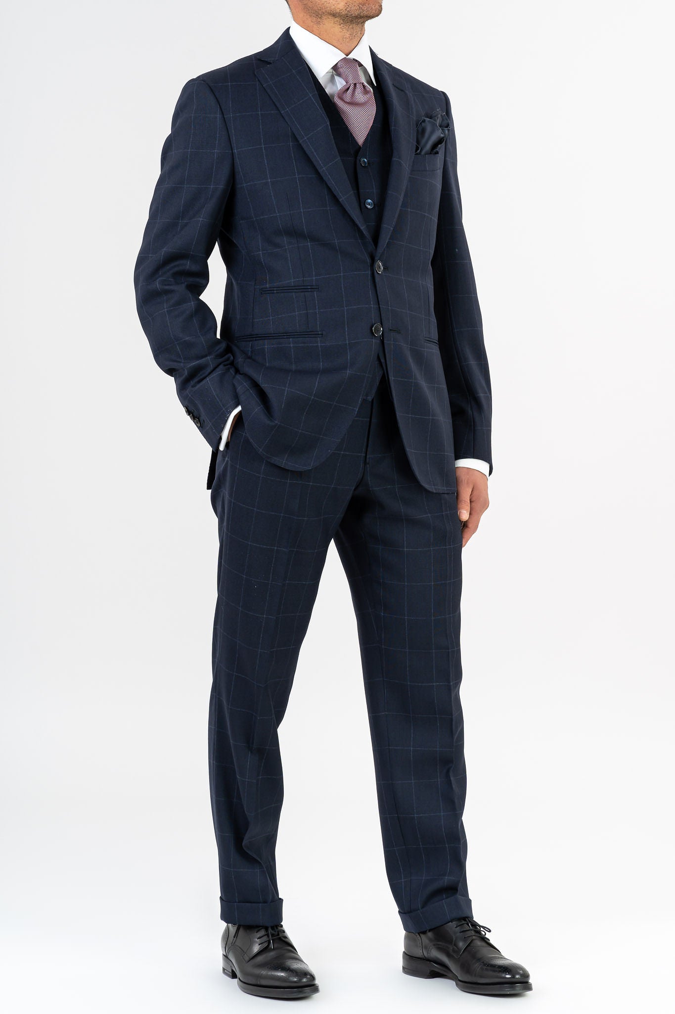 Three-piece suit, made with Loro Piana’s "Sopra Visso" wool, single-breasted,composed of a jacket with 2 buttons and welt pockets with a pocket for watch. Classic lapel and blue mother of pearl buttons. The elegant gilet has 5 buttons,the back has been made with elegant lining.The trousers have a regular waist and has only one dart,without loops with side buckle and predisposition for suspenders.Genuinely made in Italy by Sartoria dei Duchi